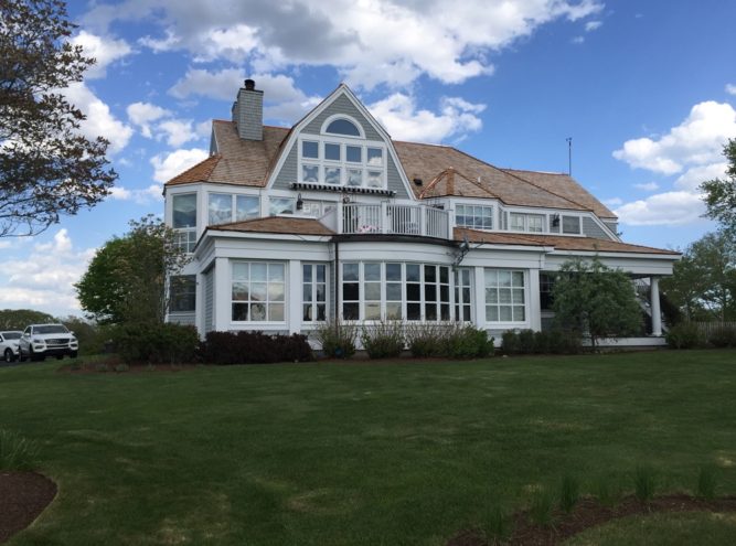 Shingle-style Massachusetts home with a completed wood shingle roof